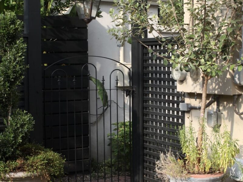 carpentry_custom_gate_copper_lantern_historic_courtyard