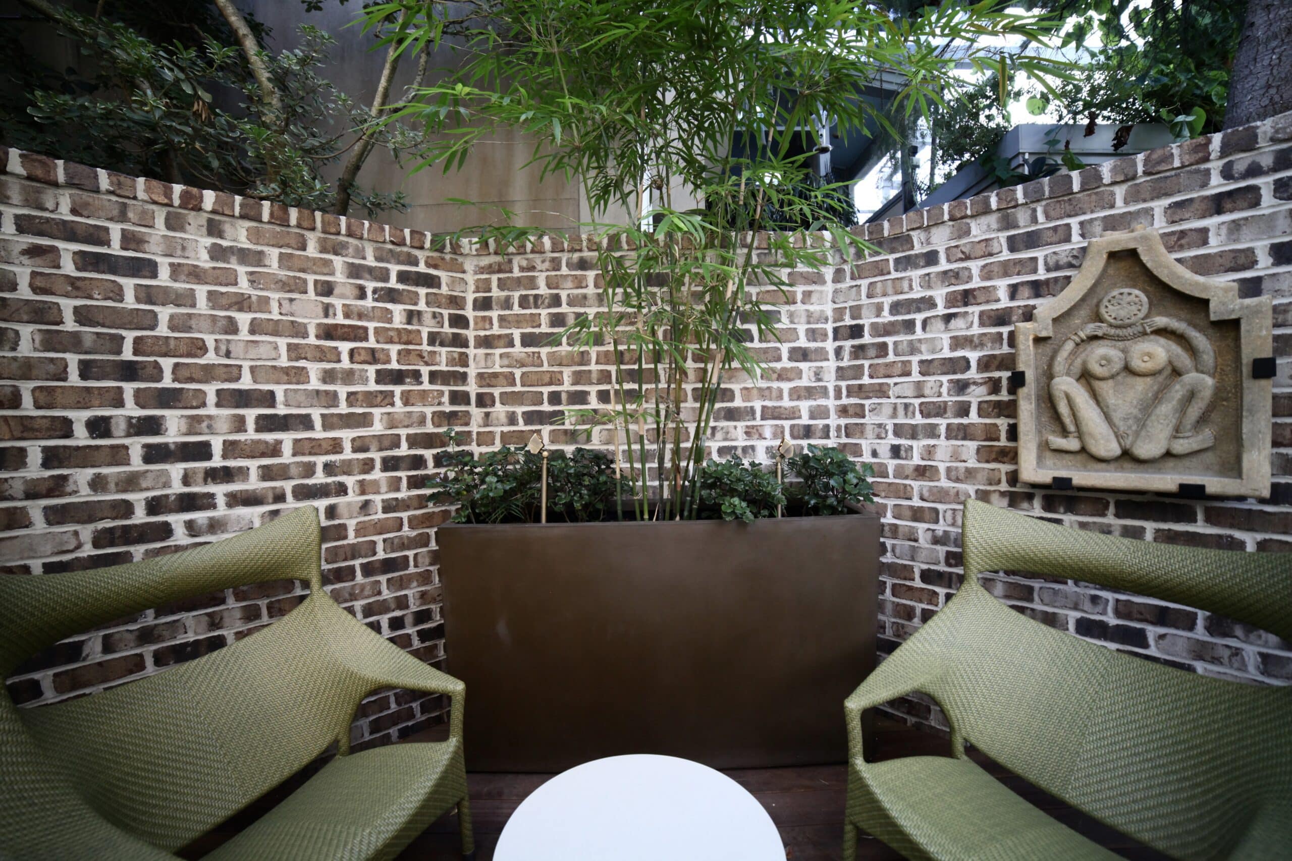 Brick-walled downtown courtyard in Savannah with a side path and lush plantings, installed by Victory Gardens.